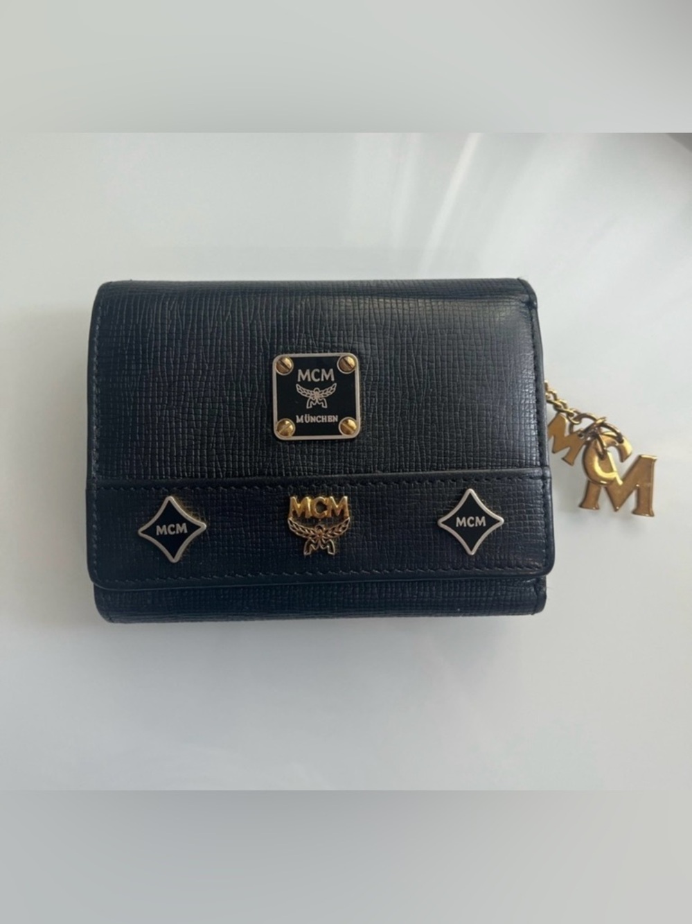 MCM Black Leather Logo Trifold Wallet with Gold Accents